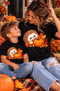 Mama and child wearing matching fall hedgehog pumpkin shirts