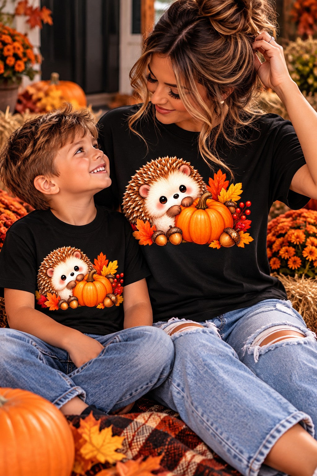 Mama and child wearing matching fall hedgehog pumpkin shirts